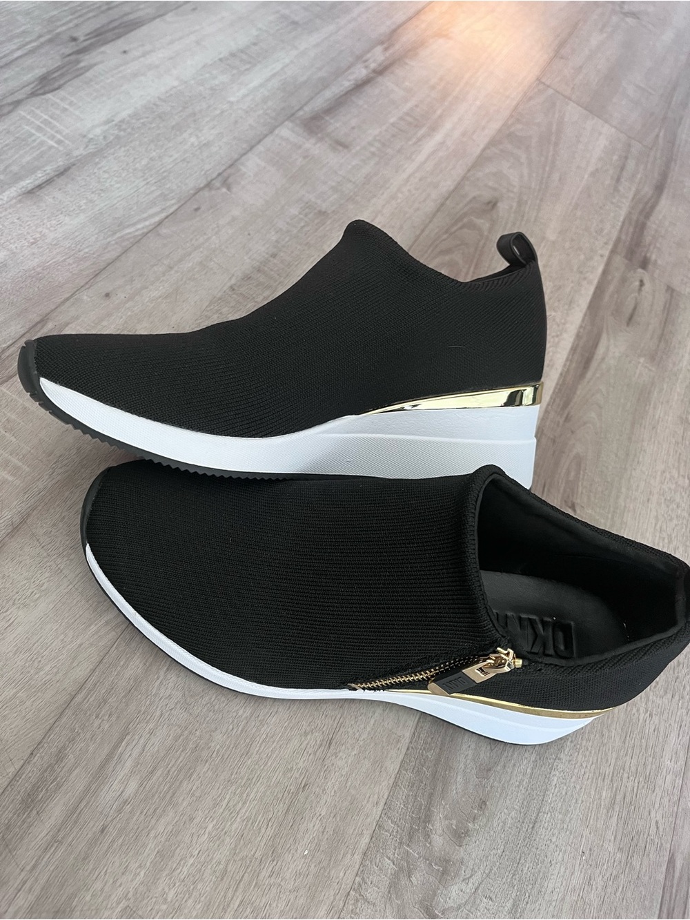DKNY Black Slip-On Wedge Sneakers with Gold Accent